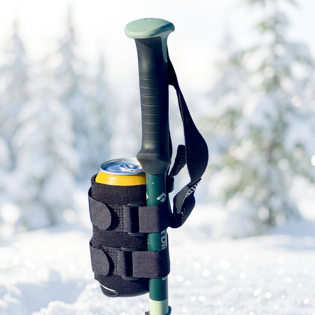 Beer Binding can holder strapped to a ski pole in the snow — a funny ski gift and stocking stuffer for skiers