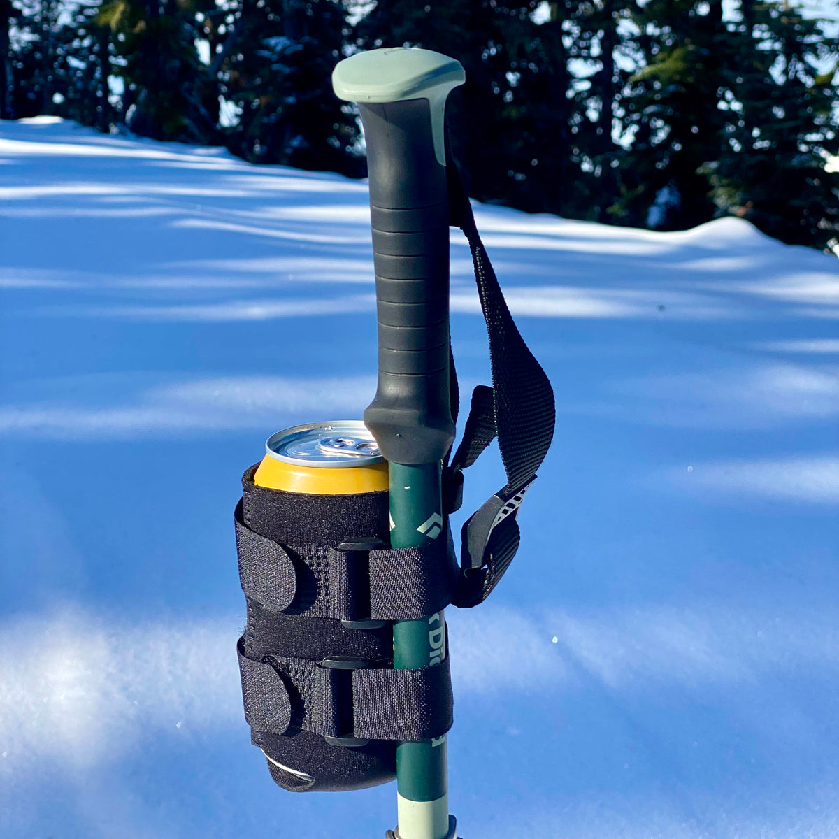 Beer Binding can holder strapped to a ski pole in the snow — a funny ski gift and stocking stuffer for skiers