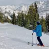 Skier with beer attached to ski pole